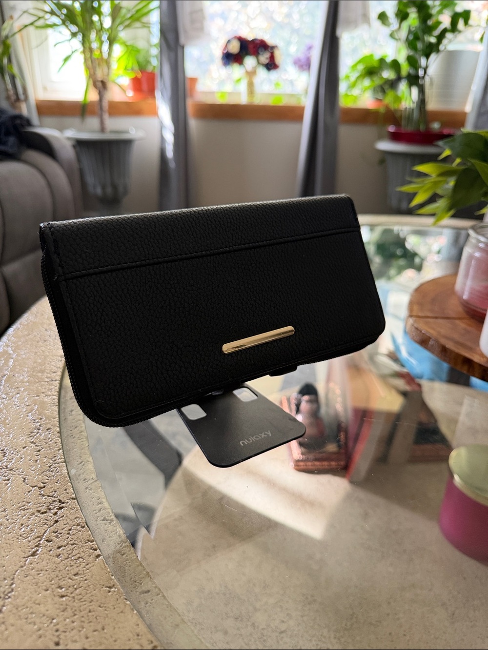 Black zip-around wallet with a texture interior gold-tone metal accent front